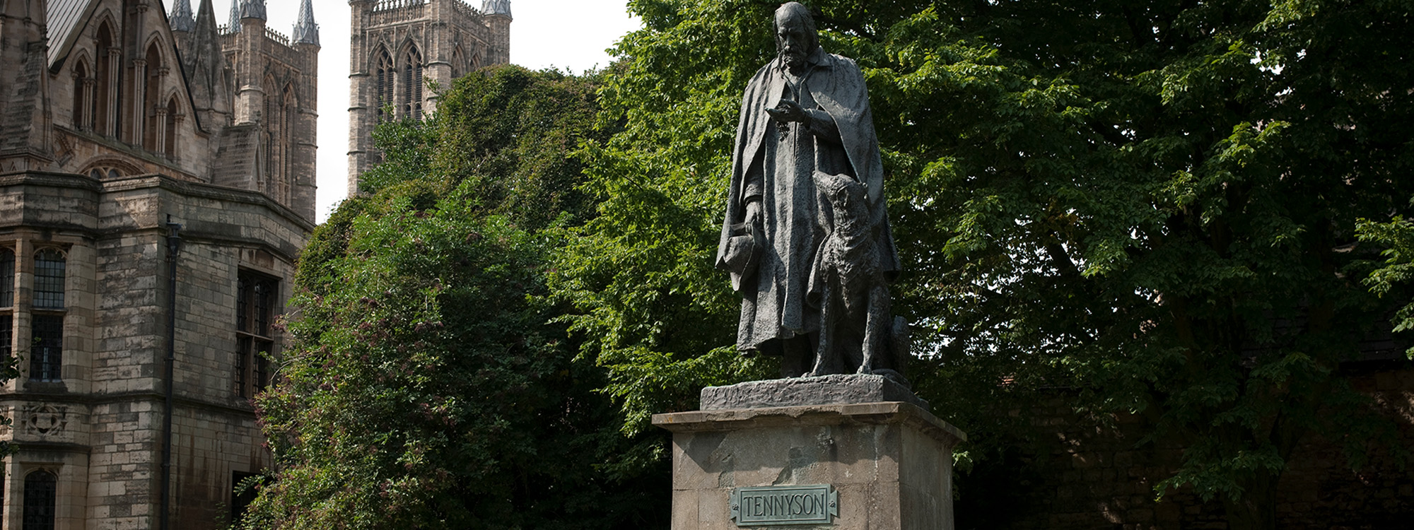 A statue of Alfred, Lord Tennyson and his dog outside Lincoln Cathedral