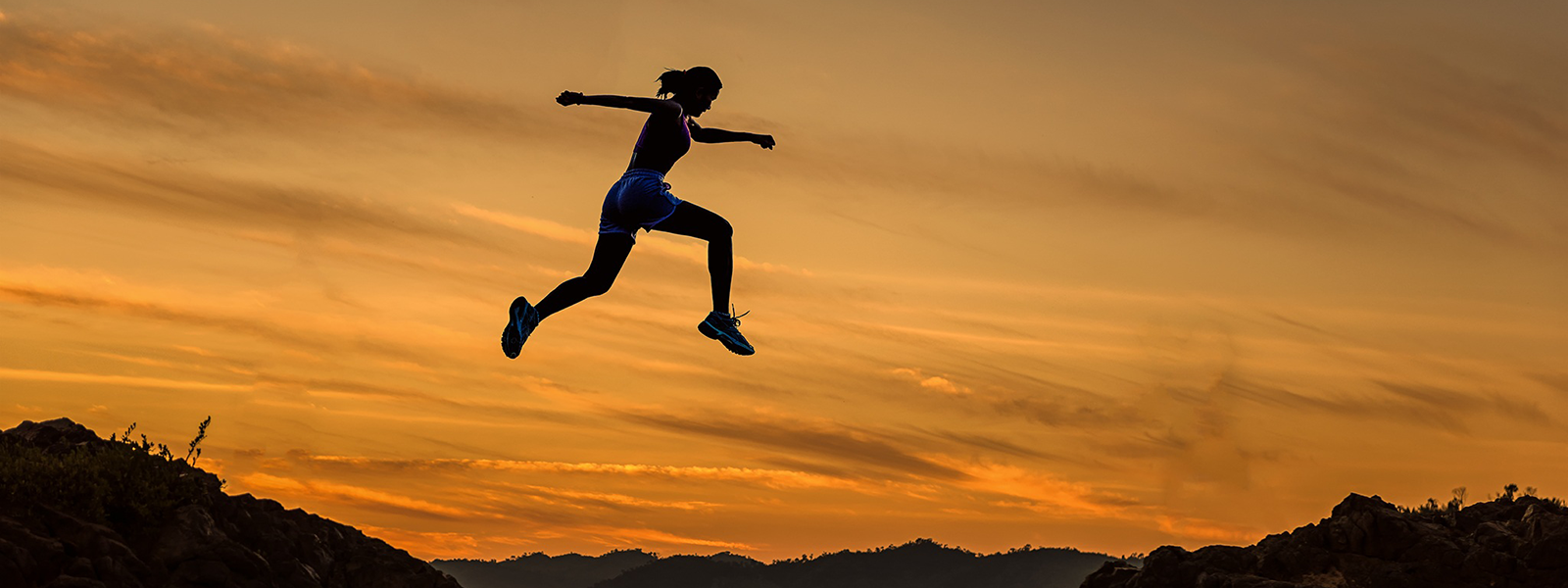 Silhouette of woman jumping