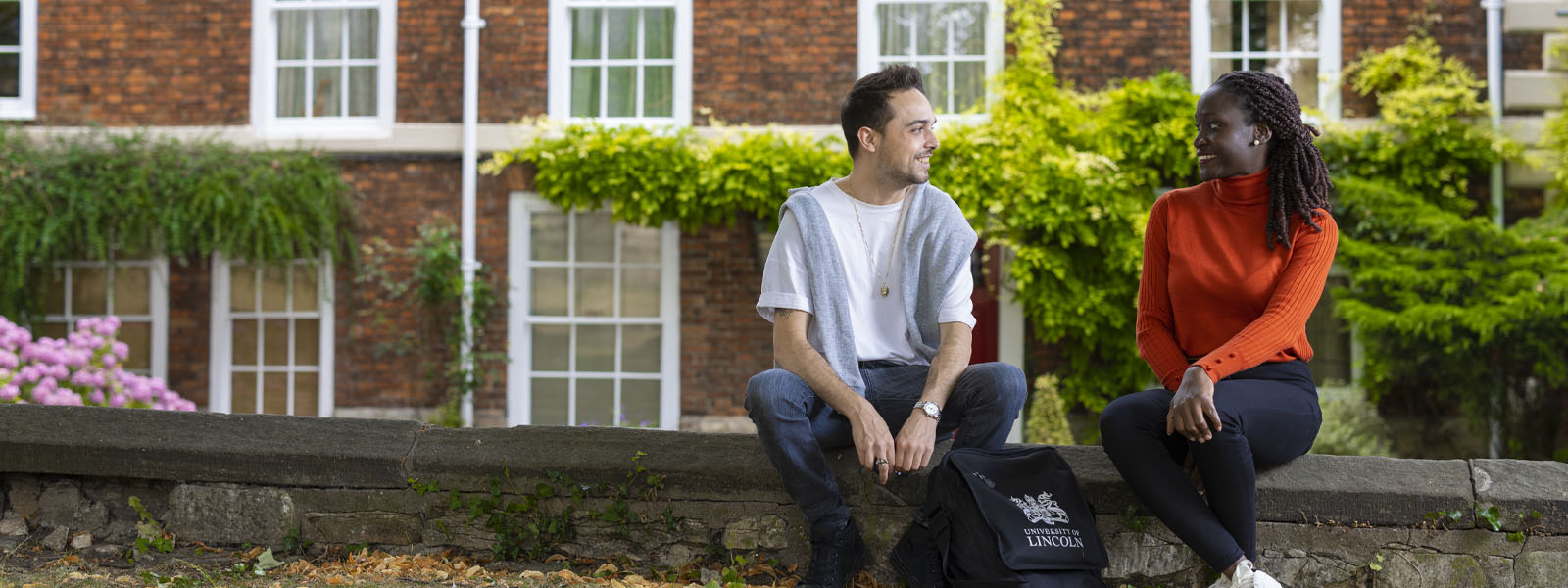Two students sat outside talking