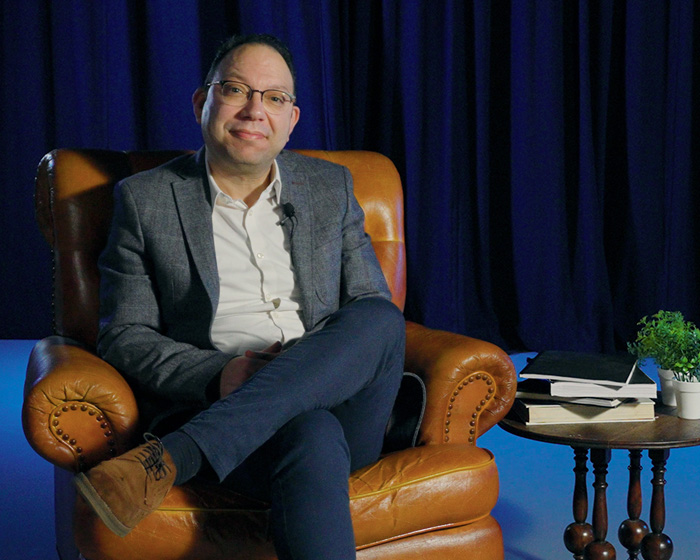 Ben Wajdi sat in an armchair with his legs crossed and smiling